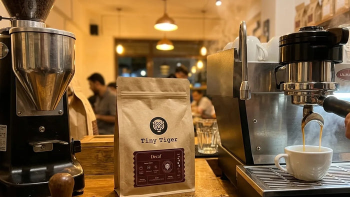 Decaf espresso pouring from a café machine in the evening