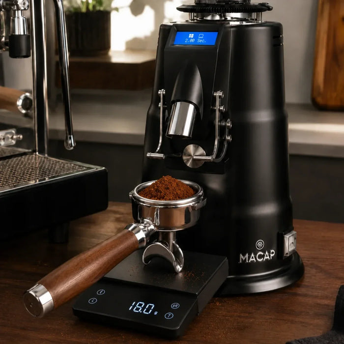 Espresso grinder dosing 18 g of coffee into a portafilter on a scale